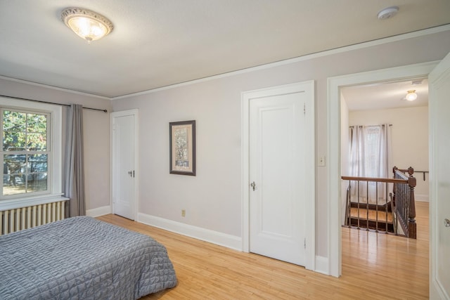 bedroom featuring hardwood / wood-style floors and ornamental molding