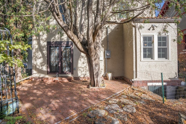 rear view of house with a patio area and french doors