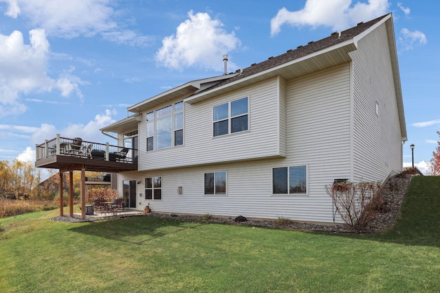 rear view of property with a wooden deck, a yard, and a patio