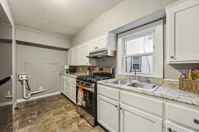 kitchen featuring white cabinetry, sink, stainless steel gas stove, and a textured ceiling