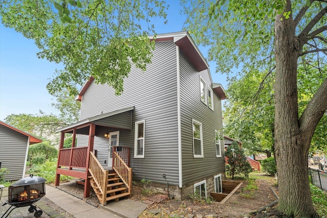 view of front of property featuring an outdoor fire pit and a wooden deck