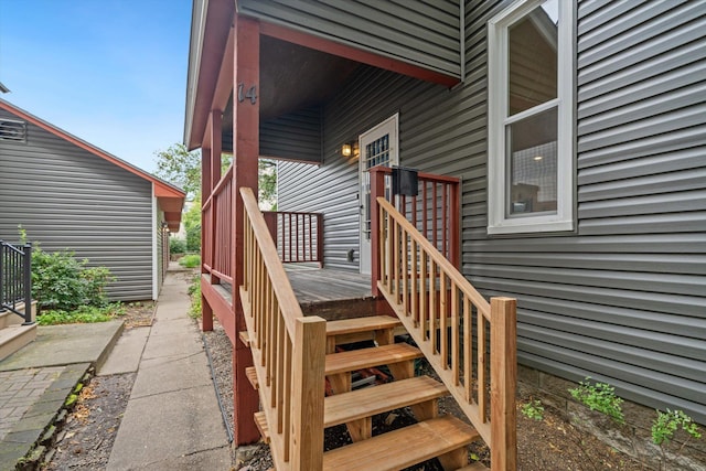 view of exterior entry featuring a wooden deck