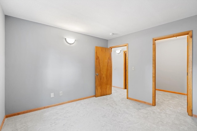 unfurnished bedroom featuring light carpet