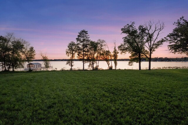 555 Bushaway Rd, Wayzata, MN 55391 - yard at dusk featuring a lawn and a water view