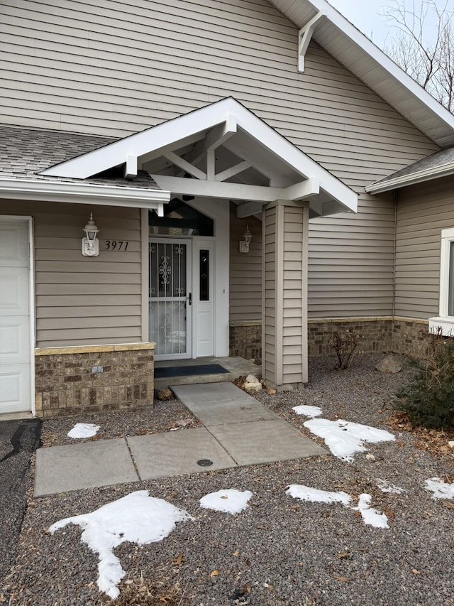 view of exterior entry with a garage