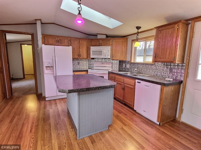 kitchen with light hardwood / wood-style floors, a center island, decorative light fixtures, lofted ceiling with skylight, and white appliances