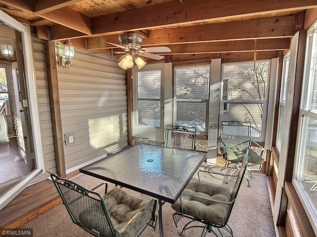 sunroom / solarium with wood ceiling, beamed ceiling, and ceiling fan