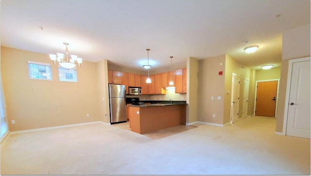 kitchen featuring stainless steel appliances, an inviting chandelier, light colored carpet, and hanging light fixtures