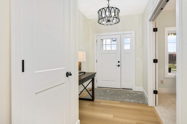 entryway featuring a chandelier and light wood-type flooring