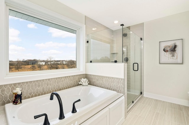 bathroom featuring tile patterned floors and separate shower and tub