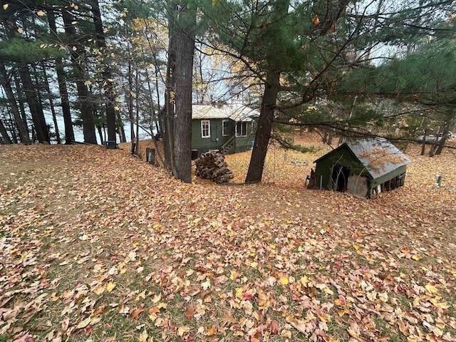 view of yard with a water view and an outbuilding