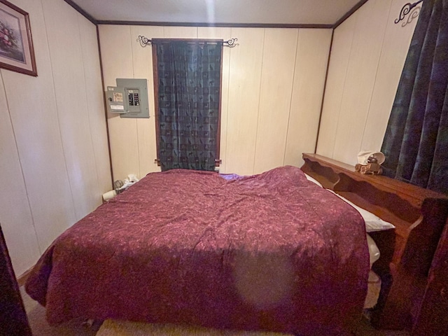 bedroom featuring ornamental molding, electric panel, and wooden walls