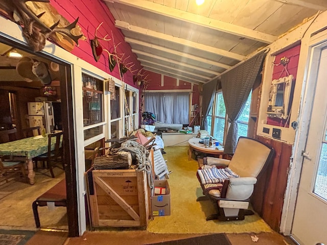 interior space featuring carpet and vaulted ceiling with beams