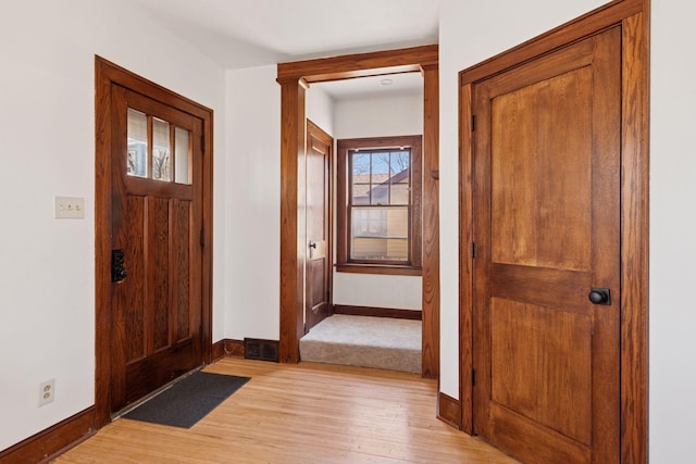 entrance foyer featuring visible vents, light wood-style flooring, and baseboards