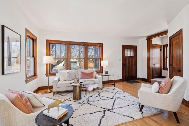 living room with baseboards and wood finished floors