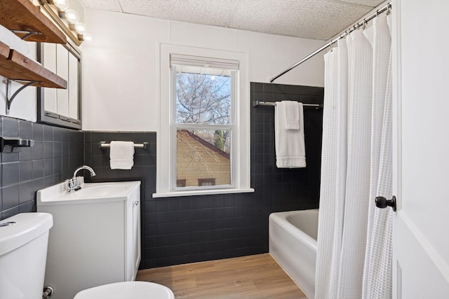 full bathroom with vanity, tile walls, toilet, and wood finished floors