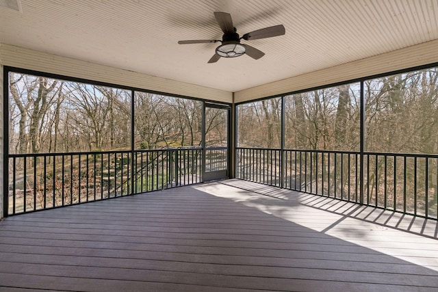 unfurnished sunroom featuring ceiling fan