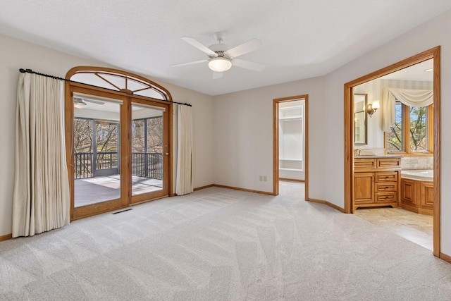 interior space featuring light carpet, visible vents, and baseboards