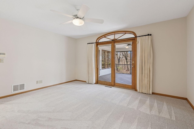 spare room with ceiling fan, baseboards, visible vents, and carpet
