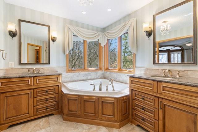 bathroom featuring wallpapered walls and a sink