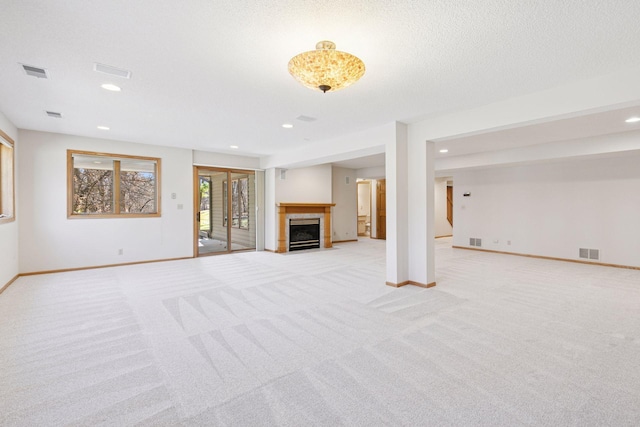 unfurnished living room with recessed lighting, baseboards, and light colored carpet