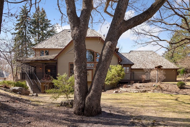 view of side of home featuring a wooden deck and stairs