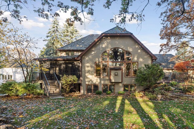 exterior space with a wooden deck, a yard, and stairway