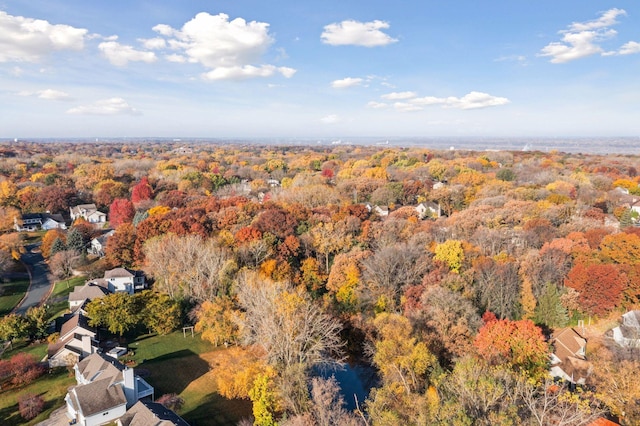 bird's eye view with a wooded view