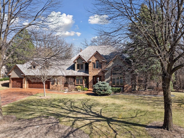 traditional home featuring concrete driveway, a front lawn, stone siding, and a garage