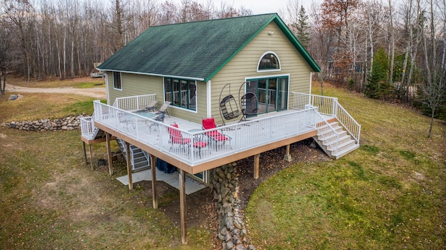 back of house featuring a yard and a wooden deck