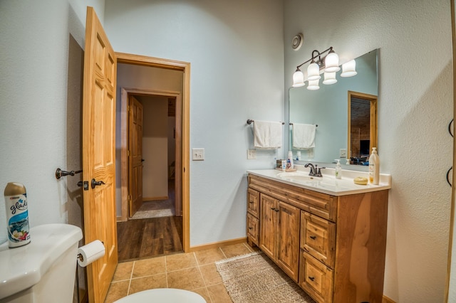 bathroom with tile patterned floors, vanity, and toilet