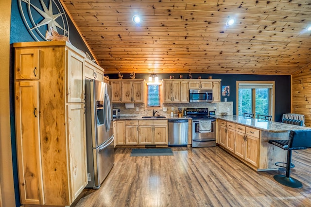 kitchen with tasteful backsplash, wooden ceiling, vaulted ceiling, and appliances with stainless steel finishes