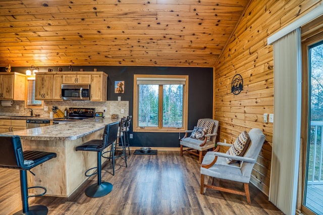 kitchen featuring wooden ceiling, dark hardwood / wood-style floors, vaulted ceiling, a breakfast bar area, and appliances with stainless steel finishes