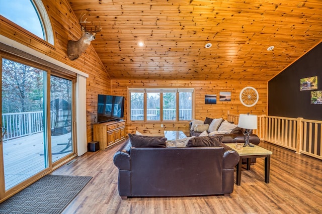 living room with high vaulted ceiling, light hardwood / wood-style flooring, wooden ceiling, and wood walls