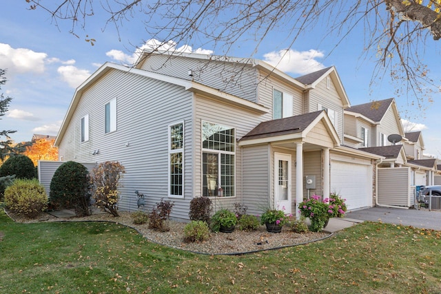 view of property exterior with a yard, aphalt driveway, and a garage