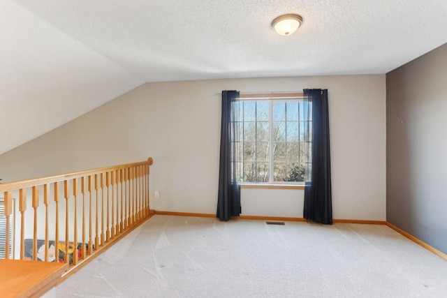 bonus room with visible vents, baseboards, a textured ceiling, and carpet flooring