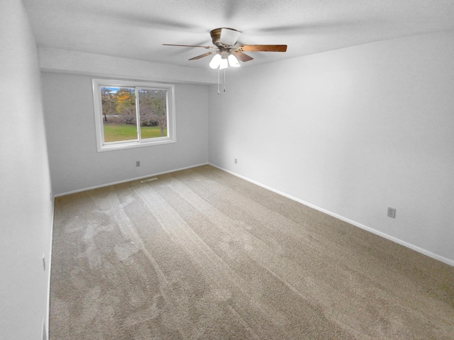 unfurnished room with carpet and ceiling fan