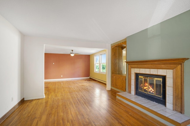 unfurnished living room featuring a fireplace, light wood-type flooring, and vaulted ceiling