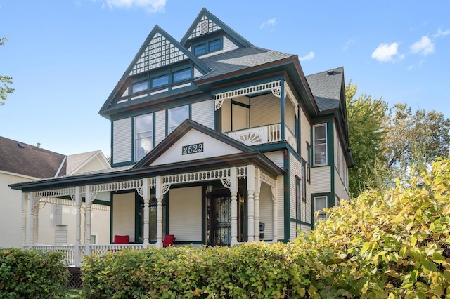 2523 Dupont Ave N, Minneapolis, MN 55411 - back of house with a porch, a shingled roof, and a balcony
