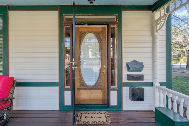 view of exterior entry with a porch