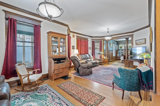 living room featuring ornamental molding and light hardwood / wood-style flooring