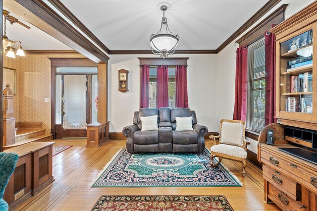 2523 Dupont Ave N, Minneapolis, MN 55411 - living room with crown molding, light wood-style flooring, and baseboards