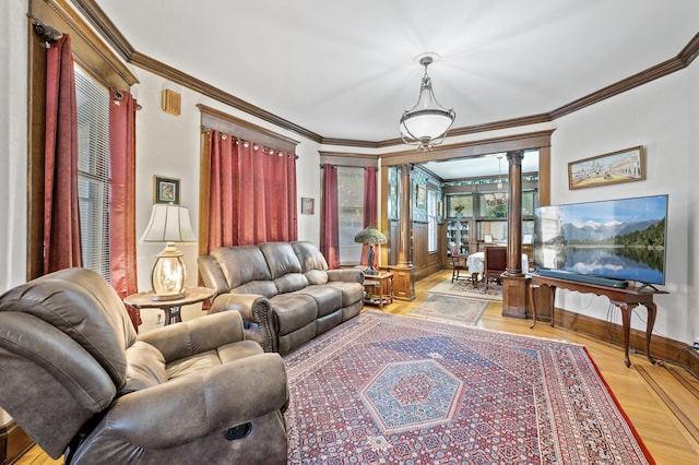 living room with crown molding, light hardwood / wood-style flooring, and decorative columns