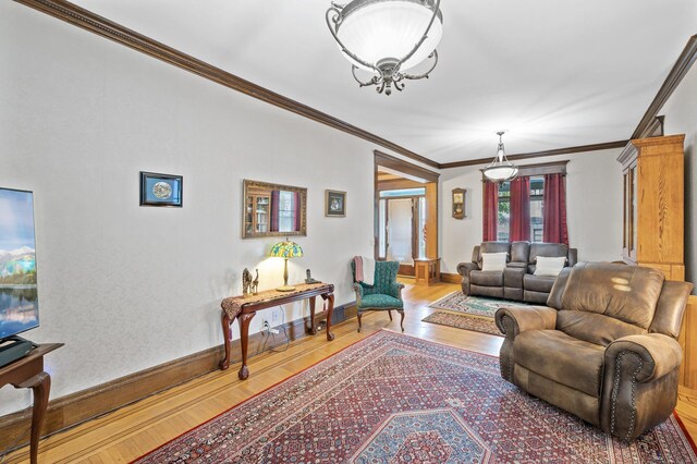 2523 Dupont Ave N, Minneapolis, MN 55411 - living room featuring wood finished floors, crown molding, and baseboards