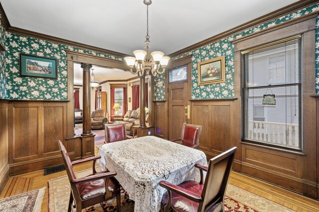 2523 Dupont Ave N, Minneapolis, MN 55411 - dining room featuring a chandelier, crown molding, wallpapered walls, and wainscoting