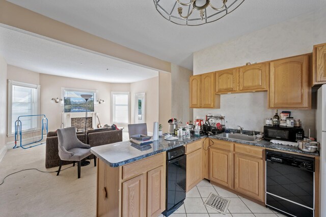 2523 Dupont Ave N, Minneapolis, MN 55411 - kitchen featuring black appliances, a wealth of natural light, a peninsula, and a sink