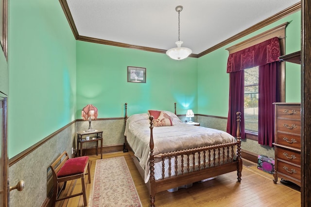 bedroom featuring crown molding and hardwood / wood-style flooring