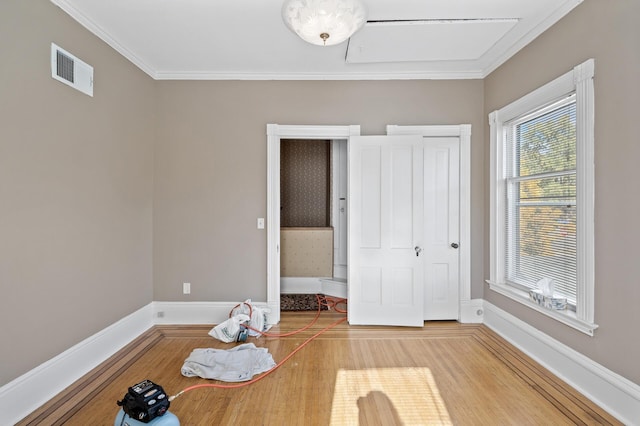 interior space with crown molding and wood-type flooring