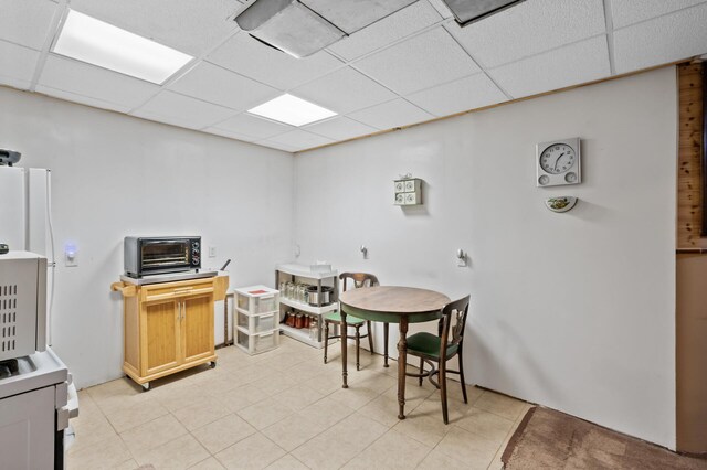 2523 Dupont Ave N, Minneapolis, MN 55411 - dining space featuring a toaster, light tile patterned floors, and a drop ceiling