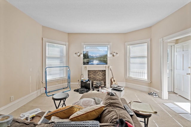 interior space featuring a textured ceiling, light colored carpet, and a brick fireplace